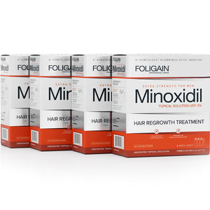 Multiple boxes of Foligain Minoxidil hair regrowth treatment on a white background