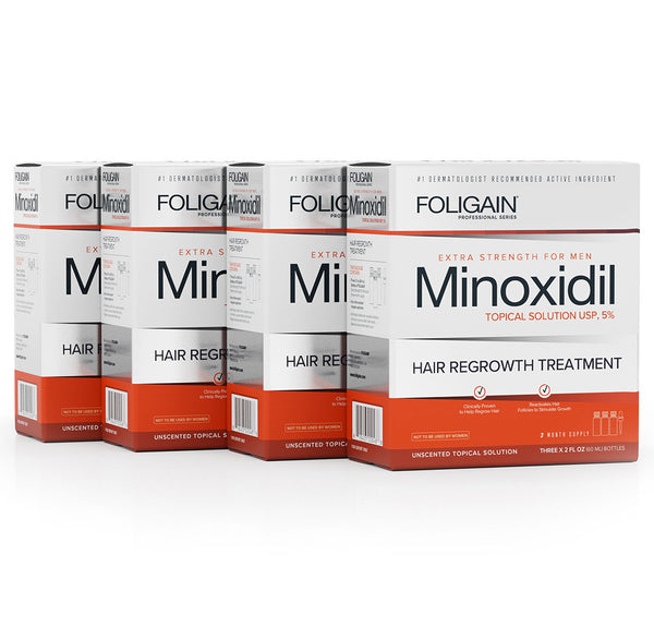 Multiple boxes of Foligain Minoxidil hair regrowth treatment on a white background