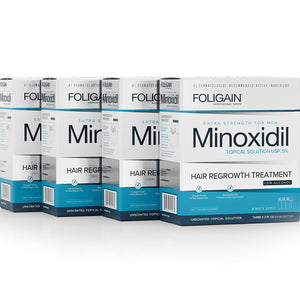 Multiple boxes of Foligain Minoxidil hair regrowth treatment on a white background
