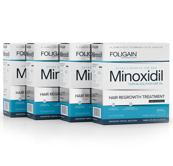 Multiple boxes of Foligain Minoxidil hair regrowth treatment on a white background