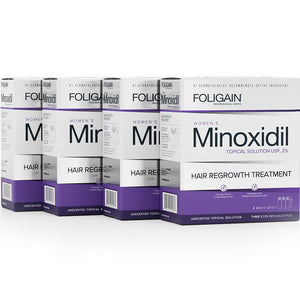 Multiple boxes of Foligain Women's Minoxidil Hair Regrowth Treatment on a white background